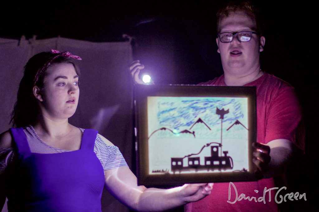 A dark scene with shadow puppetry